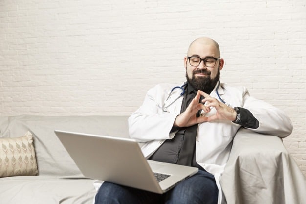 A doctor sits reading an email campaign, a digital marketing service by promo pharma